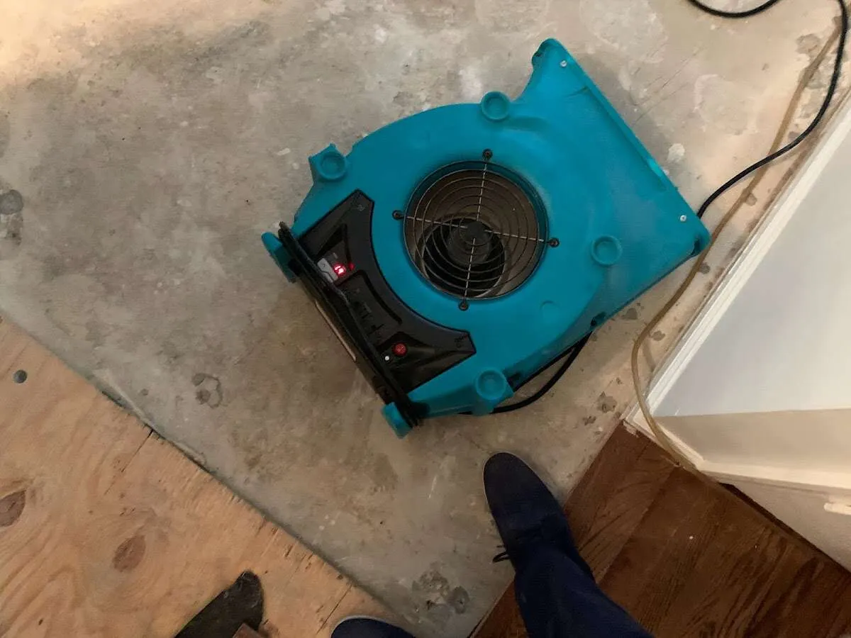 Air mover drying subfloor during Leak Detection & Repair in Stroud